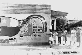 Mural en donde sale una mujer con su niño que dice si la mujer no está, la democracia no va