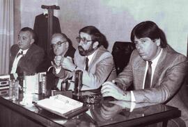 Cuatro hombres dando una conferencia de Prensa